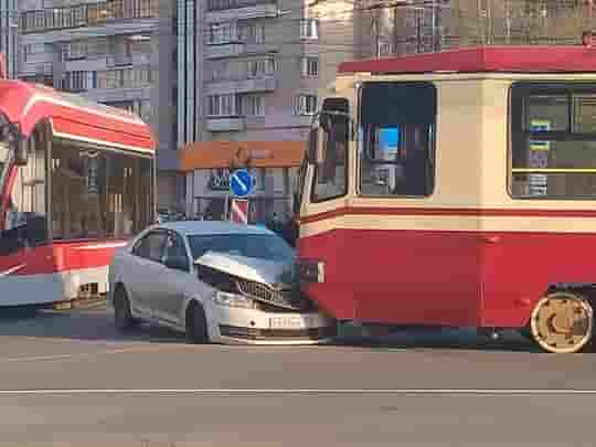 На перекрёстке Просвещения и Светлановского трамвай немного занизил белый автособиль. Пробка собирается